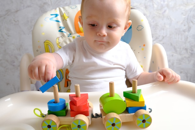 Child boy playing with toys indoors at home