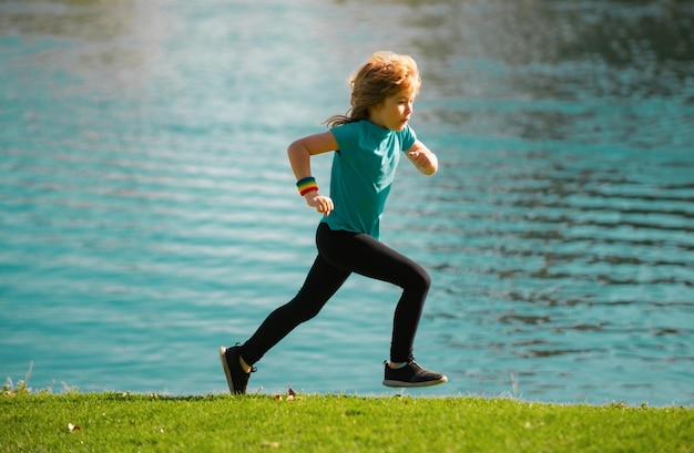 Child boy running outdoors child runner jogger running in the nature morning jogging