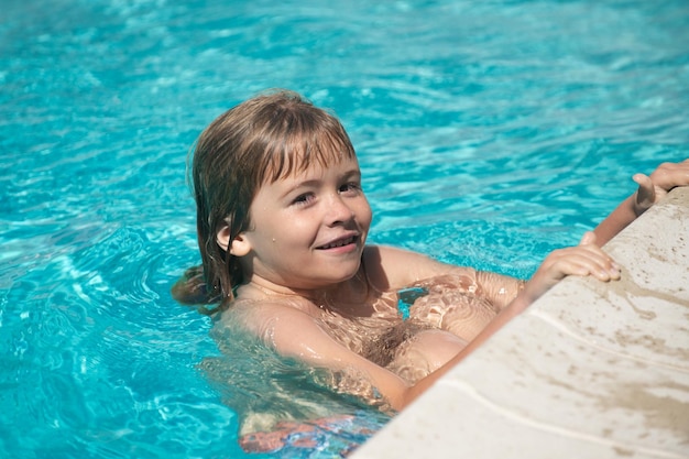 Child boy swim in swimming pool Kids summer vacation concept