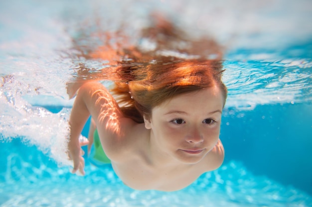 Child boy swim under water in sea kid swimming in pool underwater happy boy swims in sea underwater