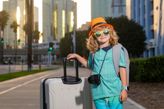 Child boy and travel Suitcase Kid and Luggage Packed for vacation child trip Little tourist with travel bag Child traveler and baggage Kid with luggage bags going on holiday trip