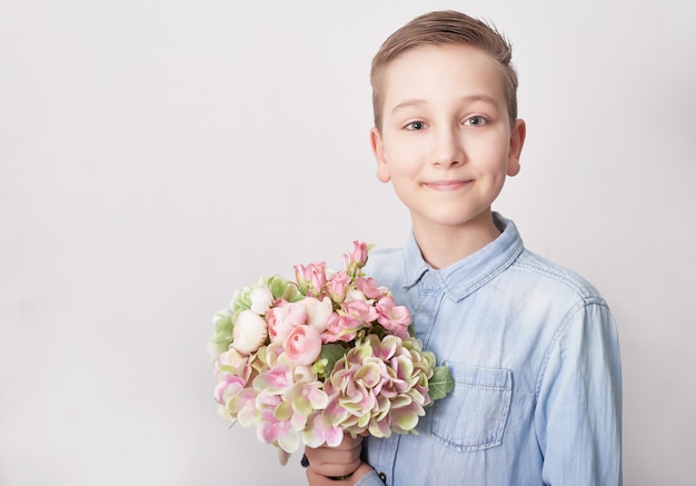 Child boy with bouquet of flowers. Mother's Day 