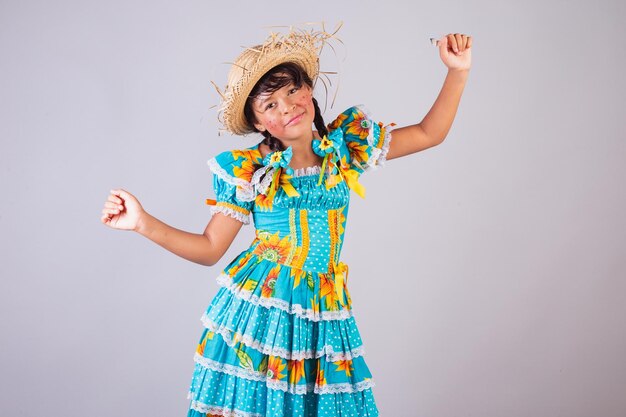 Child Brazilian girl with Festa Junina clothes dancing