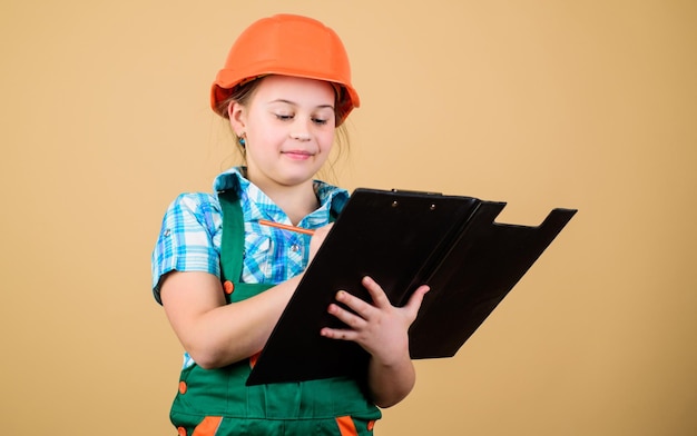 Child care development. Safety expert. Future profession. Foreman inspector. Repair. Builder engineer architect. Kid worker in hard hat. small girl repairing in workshop. My workshop and my rules.