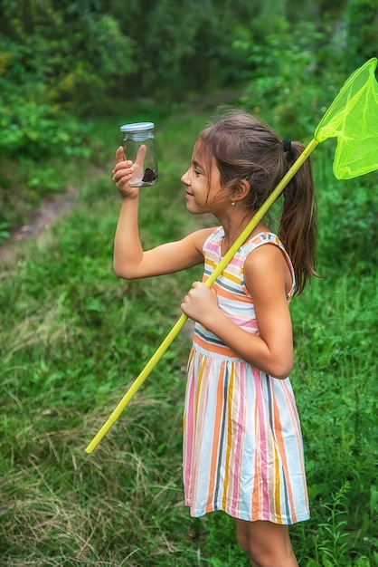 The child catches butterflies in nature. Selective focus. ,