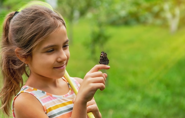 The child catches butterflies in nature. Selective focus. ,