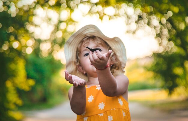 A child catches a butterfly in nature selective focus