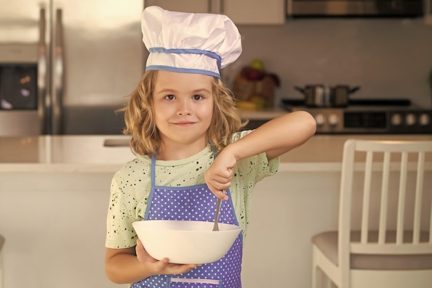 Child chef cook with cooking plate children cooking in the kitchen funny kid chef cook cookery at