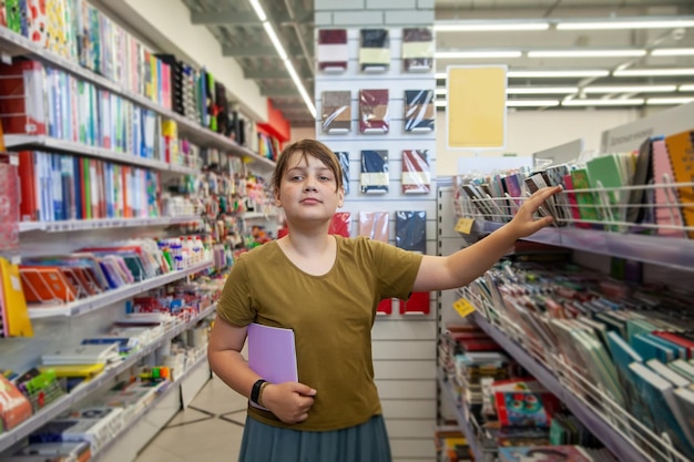 Child choosing school stationery in supermarket