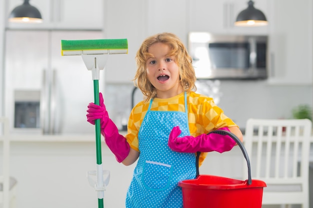 Child cleans at home concept Kid cleaning with mop to help with housework Little cute boy sweeping