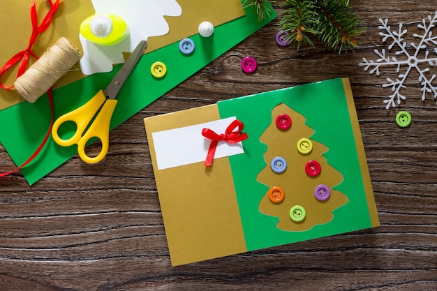 The child creates Christmas greeting cards paper