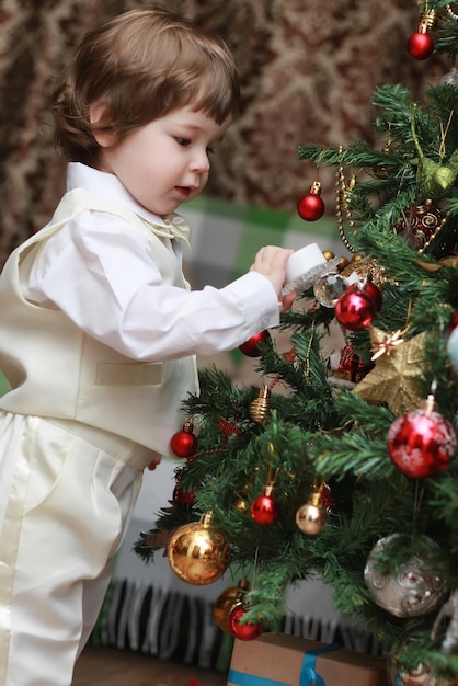 Child decorate the Christmas tree toy