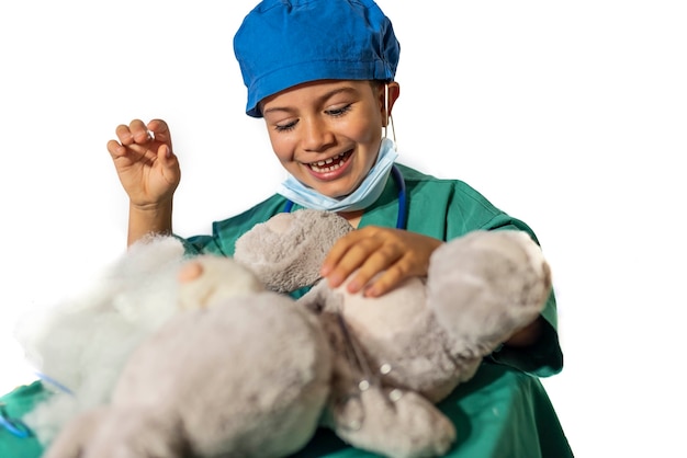 child disguised as a surgeon operates a teddy bear