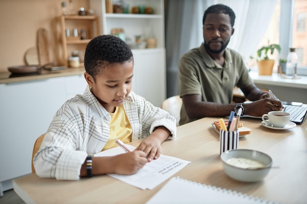 Child doing homework at kitchen table