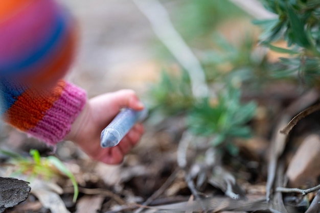 child doing science toddler with test tubes outside in natural in the bush