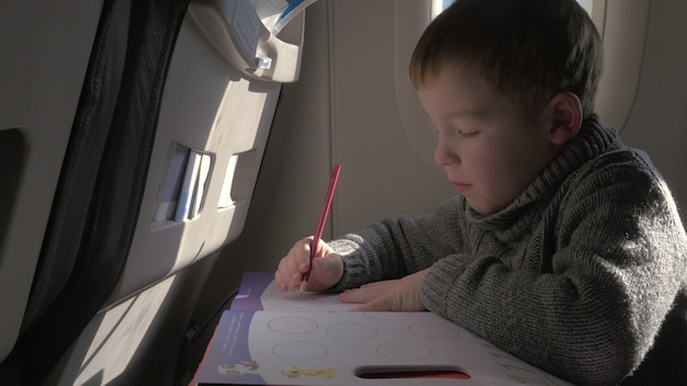 Child drawing during the flight