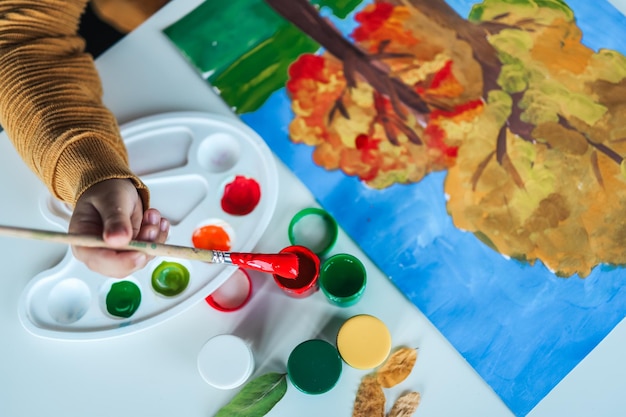 Child draws with paints drawing master class