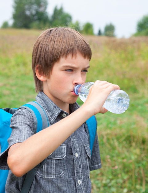 Child drinking water while traveling