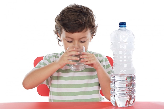 Child drinking water a over white background