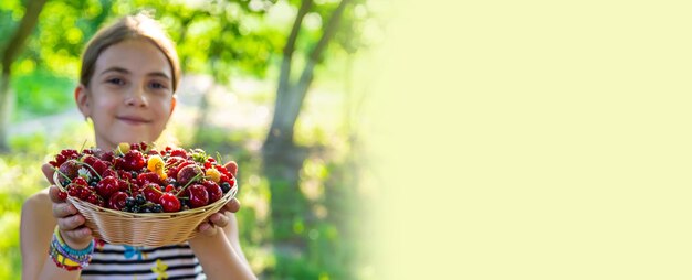 The child eats berries in the garden Selective focus