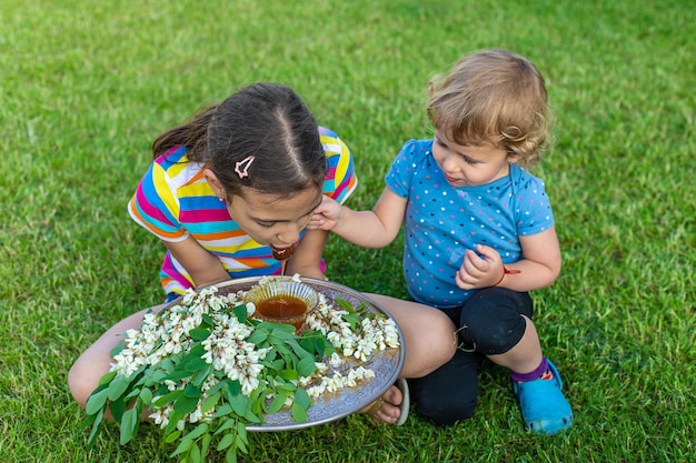 The child eats honey in the garden Selective focus