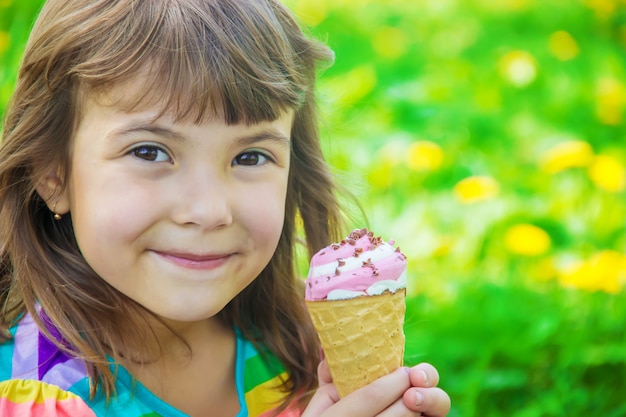 The child eats ice cream. Selective focus.