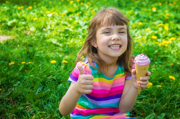 The child eats ice cream. Selective focus.