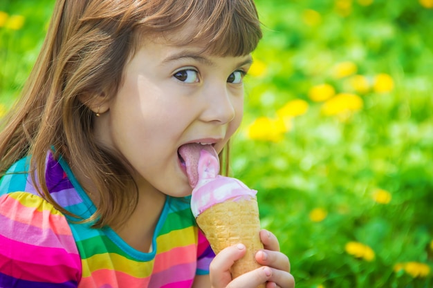 The child eats ice cream. Selective focus.