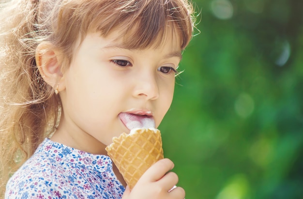 The child eats ice cream. Selective focus.