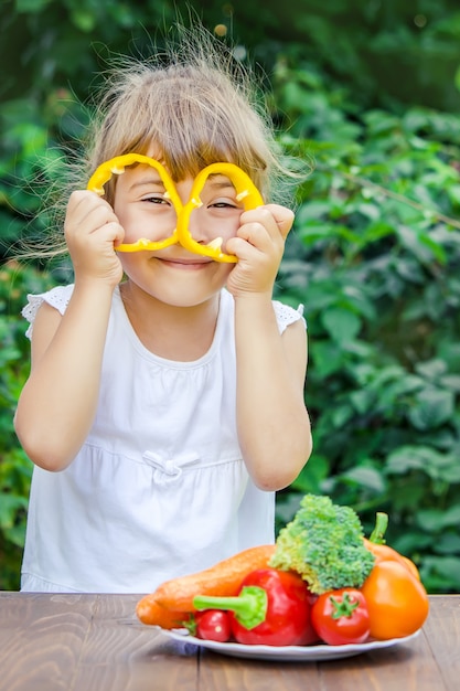 Child eats vegetables.