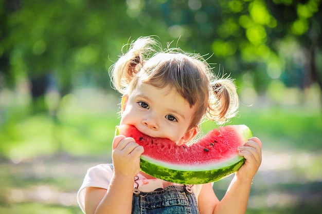 A child eats watermelon. Selective focus.