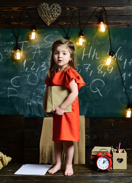 Child educational concept schoolchildren in a classroom kid pupil little girl think