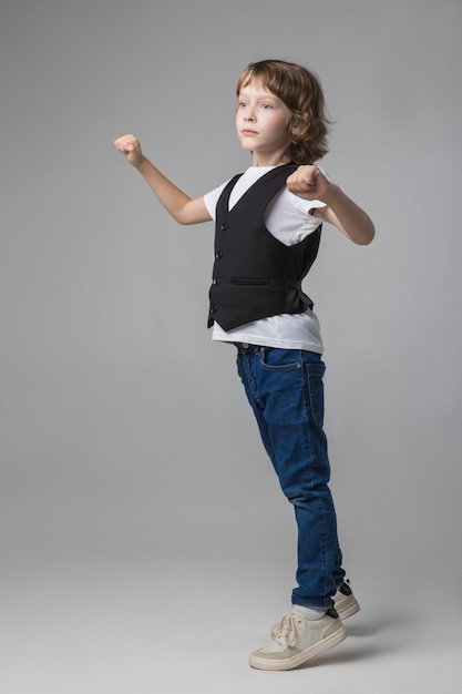 Child emotionally posing on camera in the Studio on a white background