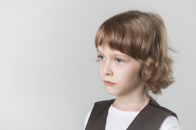 Child emotionally posing on camera in the Studio on a white background