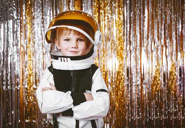 Child in fancy dress of astronaut pilot costume having fun at masquerade party