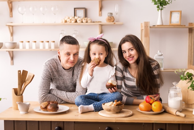 Child feeds parents in the kitchen