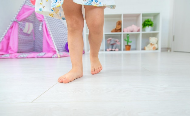 Child feet in the children's room Selective focus