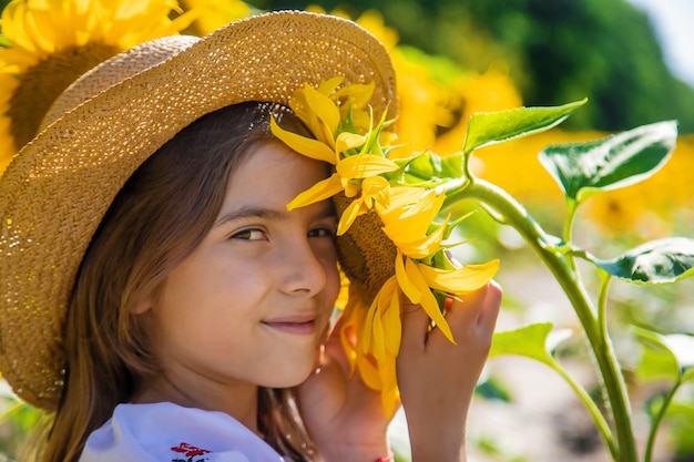 A child in a field of sunflowers in an embroidered shirt. Ukraine Independence Day concept. Selective focus.