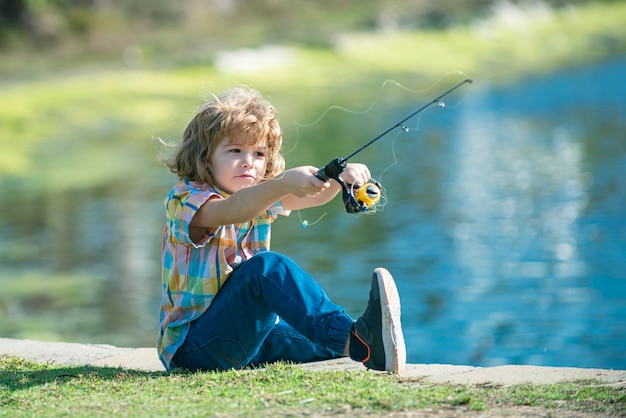 Child fishing at river or lake Young kid fisher Summer outdoor leisure activity Little boy angling at river with rod