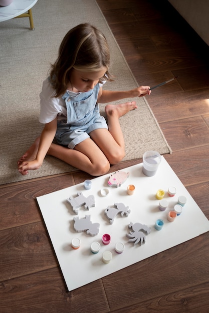 Child on floor with brush full shot