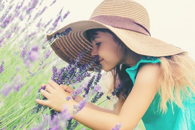 A child in a flowering field of lavender. Selective focus.