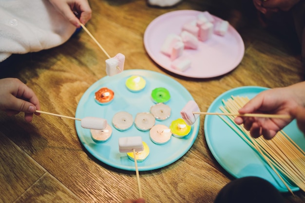 한 아이가 마시멜로를 불에 튀깁니다Fried marshmallows closeup