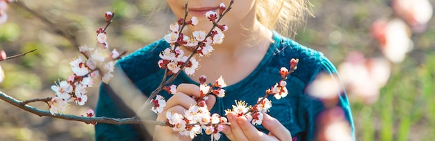 A child in the garden of flowering trees