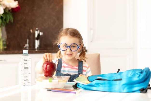 Bambino prepararsi scuola a casa mattina di sole cucina zainolibroeducazioneapprendimentoritorno a scuola