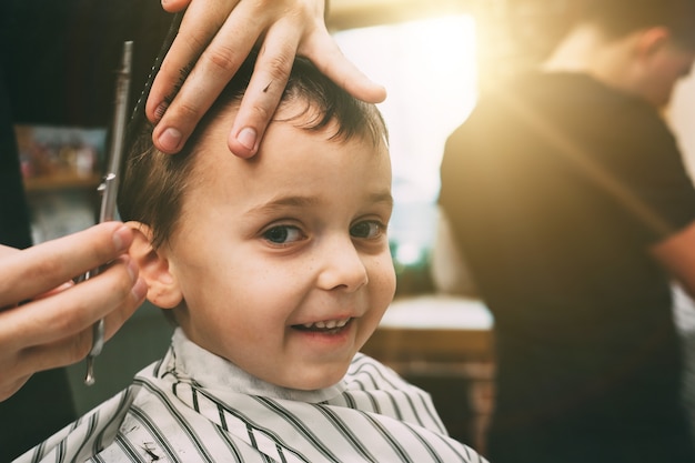 Child getting his haircut at the barbershop