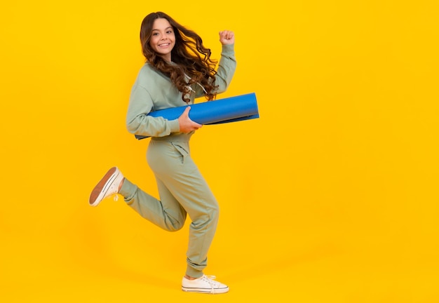 Child girl dressed in sports uniform Child in a posh stylish sports suit in a hoodie with a hood