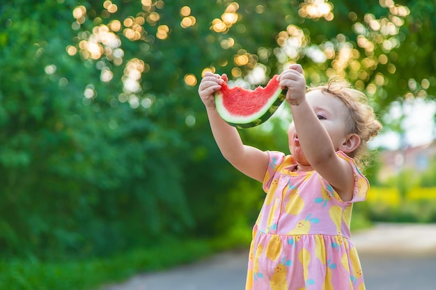 Child girl eats watermelon in summer Selective focus