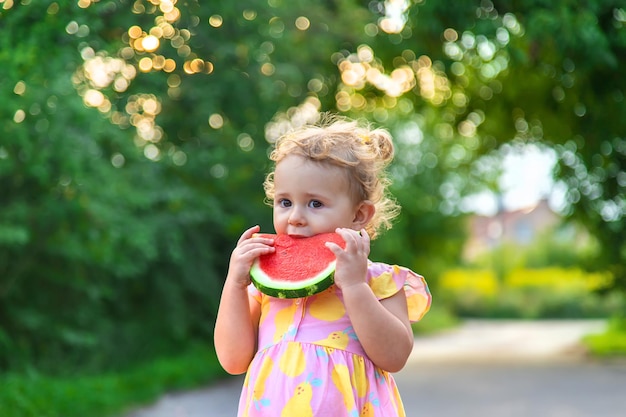 Child girl eats watermelon in summer Selective focus