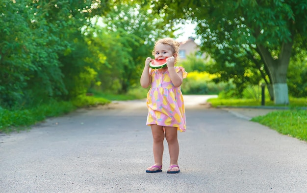 Child girl eats watermelon in summer Selective focus
