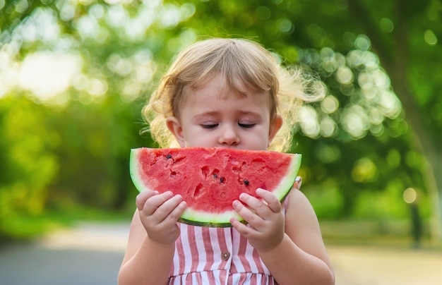 Child girl eats watermelon in summer Selective focus